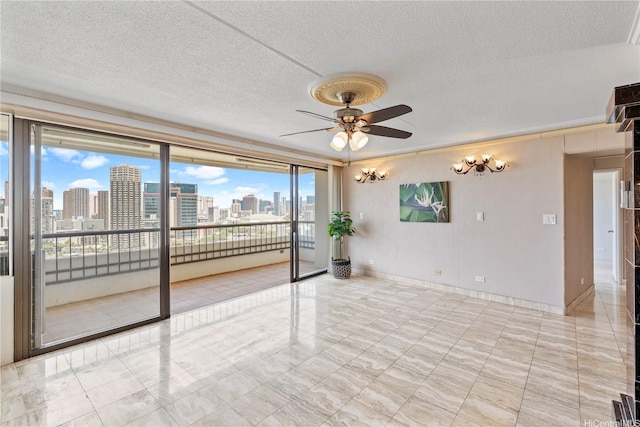 2333 Kapiolani Blvd Unit 2211, Honolulu, HI 96826 - empty room featuring a ceiling fan, a skyline view, a textured ceiling, and baseboards