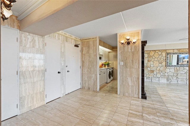 2333 Kapiolani Blvd Unit 2211, Honolulu, HI 96826 - unfurnished living room with washer / clothes dryer, a chandelier, ornamental molding, and tile walls