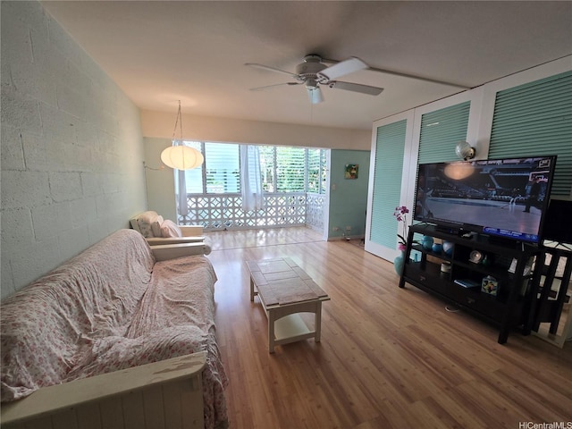 3061 Pualei Cir Unit 105, Honolulu, HI 96815 - living room featuring ceiling fan, wood finished floors, and concrete block wall