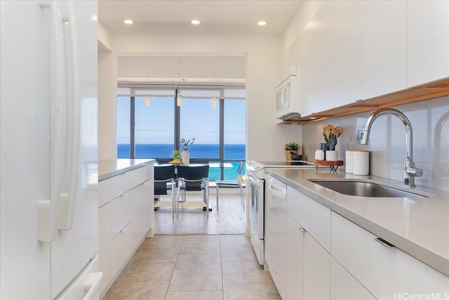 229 Paoakalani Ave Unit Ph-3807, Honolulu, HI 96815 - kitchen featuring white appliances, white cabinetry, light countertops, light tile patterned flooring, and recessed lighting