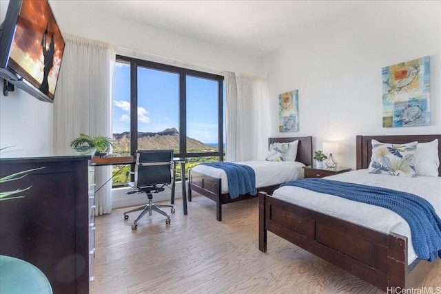 229 Paoakalani Ave Unit Ph-3807, Honolulu, HI 96815 - bedroom with wood finished floors, a desk, and a mountain view