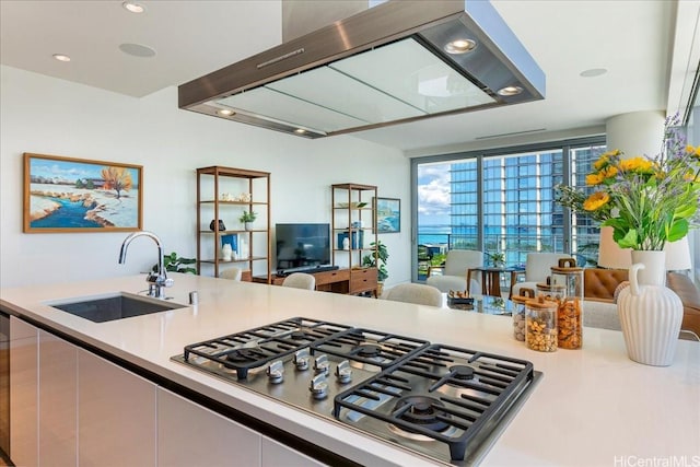 1118 Ala Moana Blvd Unit 2505, Honolulu, HI 96814 - kitchen with a sink, stainless steel gas cooktop, light countertops, white cabinets, and recessed lighting