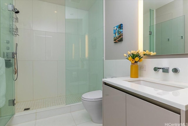 1118 Ala Moana Blvd Unit 2505, Honolulu, HI 96814 - full bathroom featuring toilet, vanity, a stall shower, tile patterned flooring, and tile walls