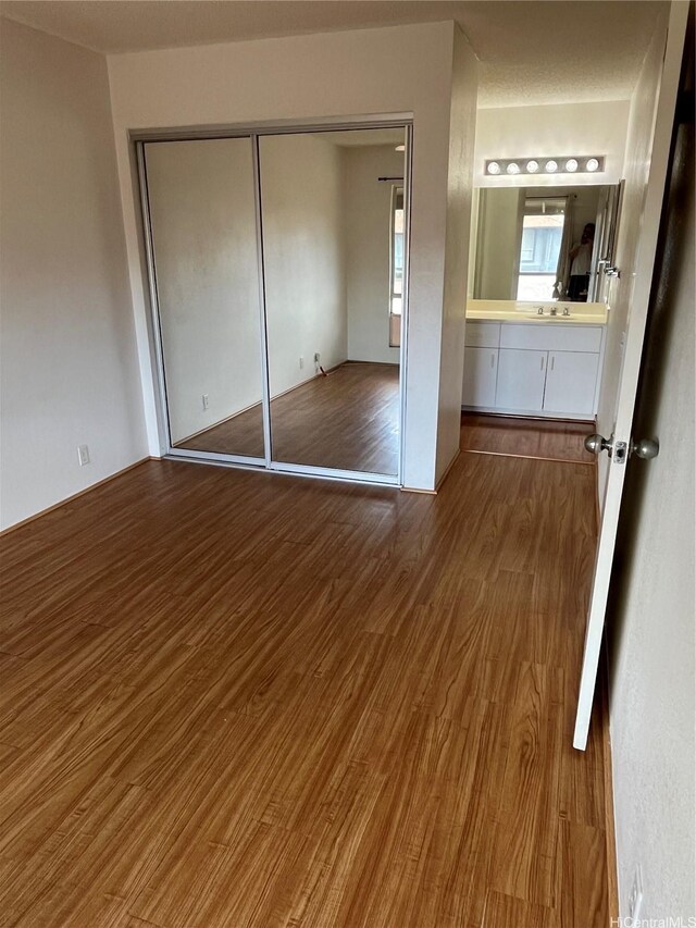 91-1059 Puamaeole St Unit 5W, Ewa Beach, HI 96706 - unfurnished bedroom with wood finished floors and a closet