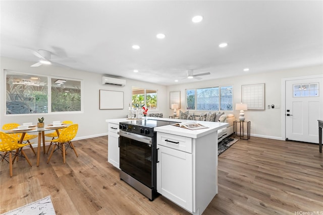85-310 Kohai Pl, Waianae, HI 96792 - kitchen with a wall unit AC, a ceiling fan, black electric range oven, baseboards, and recessed lighting
