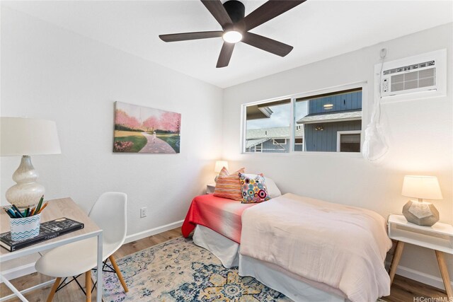 85-310 Kohai Pl, Waianae, HI 96792 - bedroom with baseboards, wood finished floors, a ceiling fan, and an AC wall unit