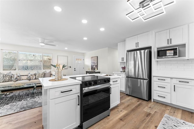 85-310 Kohai Pl, Waianae, HI 96792 - kitchen featuring appliances with stainless steel finishes, light countertops, decorative backsplash, recessed lighting, and a ceiling fan