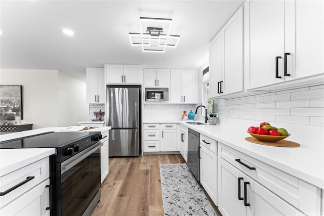 85-310 Kohai Pl, Waianae, HI 96792 - kitchen featuring stainless steel appliances, white cabinetry, a sink, light countertops, and recessed lighting