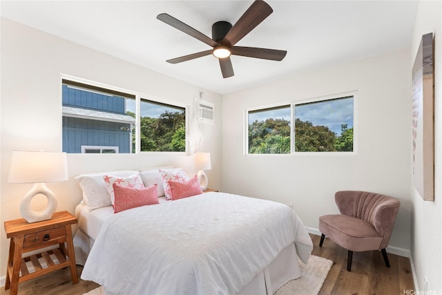 85-310 Kohai Pl, Waianae, HI 96792 - bedroom with multiple windows, wood finished floors, a wall mounted AC, and baseboards