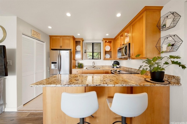 46-55 Meheanu Pl Unit 3441, Kaneohe, HI 96744 - kitchen with appliances with stainless steel finishes, a peninsula, recessed lighting, light stone counters, and a breakfast bar
