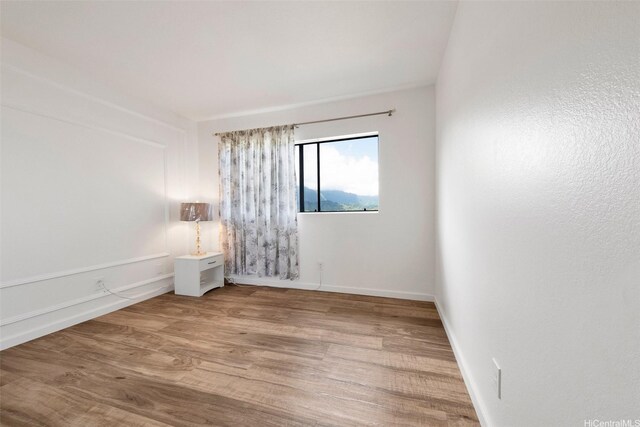 46-55 Meheanu Pl Unit 3441, Kaneohe, HI 96744 - spare room with wood finished floors and baseboards