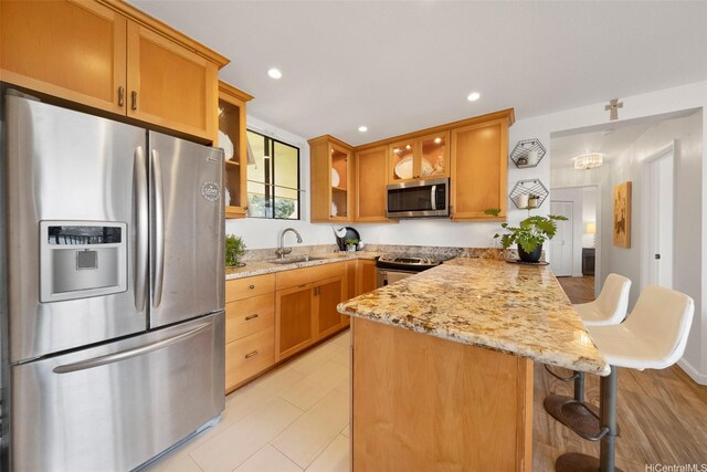 46-55 Meheanu Pl Unit 3441, Kaneohe, HI 96744 - kitchen featuring stainless steel appliances, a peninsula, glass insert cabinets, a sink, and light stone countertops