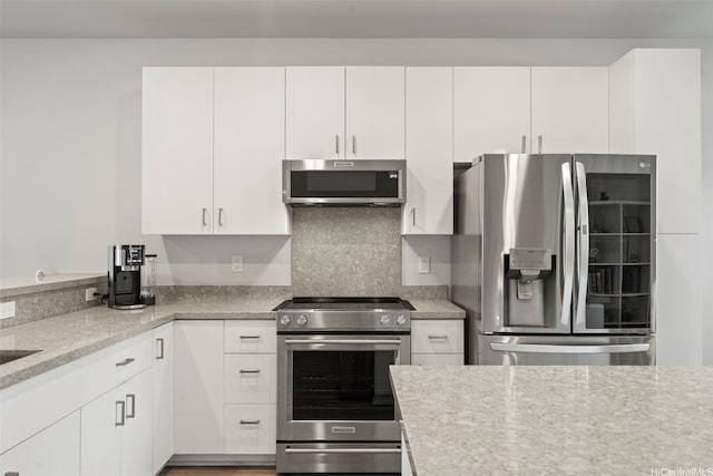 91-1774 Kohanahana Loop, Ewa Beach, HI 96706 - kitchen with stainless steel appliances, white cabinetry, and light stone counters