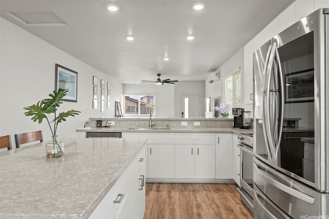 91-1774 Kohanahana Loop, Ewa Beach, HI 96706 - kitchen with stainless steel refrigerator with ice dispenser, stove, an AC wall unit, recessed lighting, and light wood finished floors