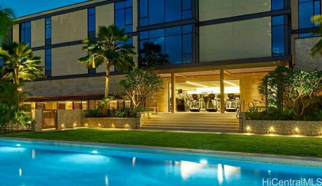 1388 Ala Moana Blvd Unit 5603, Honolulu, HI 96814 - back of house at twilight with an outdoor pool and a lawn