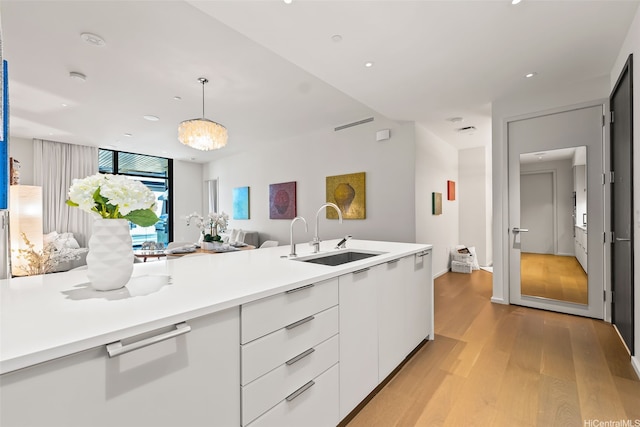 1388 Ala Moana Blvd Unit 5603, Honolulu, HI 96814 - kitchen featuring open floor plan, light wood-style floors, white cabinetry, light countertops, and modern cabinets