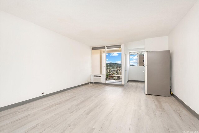 747 Amana St Unit 1607, Honolulu, HI 96814 - spare room with light wood-type flooring and a wall mounted air conditioner