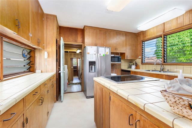 146 Kaluamoo St, Kailua, HI 96734 - kitchen featuring stainless steel refrigerator with ice dispenser, a sink, black microwave, tile countertops, and backsplash