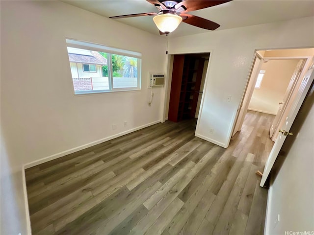 790 Ipuai St, Honolulu, HI 96825 - unfurnished bedroom with wood finished floors, baseboards, a wall mounted air conditioner, and ceiling fan