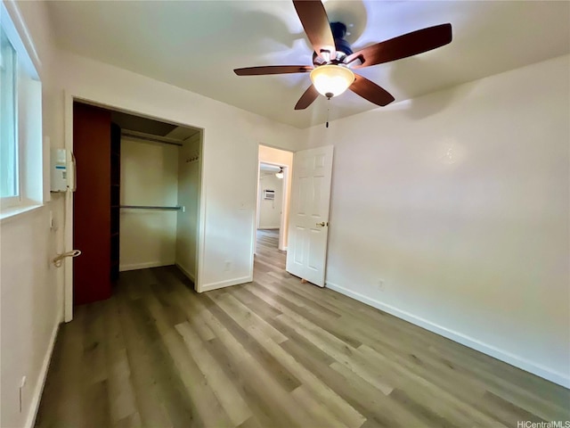 790 Ipuai St, Honolulu, HI 96825 - unfurnished bedroom with wood finished floors, baseboards, a closet, and a ceiling fan