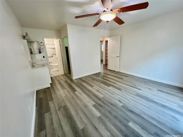 790 Ipuai St, Honolulu, HI 96825 - unfurnished bedroom featuring wood finished floors, baseboards, ensuite bathroom, and a ceiling fan