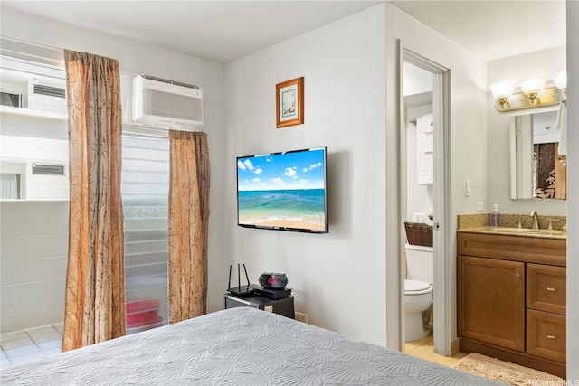 2463 Kuhio Ave Unit 607, Honolulu, HI 96815 - bedroom with light tile patterned floors, a sink, ensuite bath, and an AC wall unit