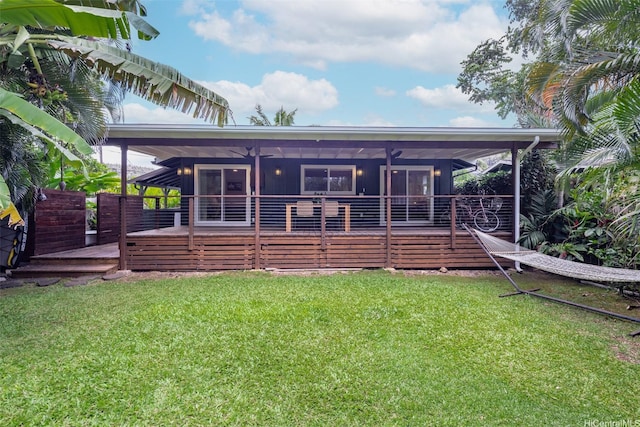 59-029 Huelo St, Haleiwa, HI 96712 - rear view of house featuring a sunroom, a wooden deck, a ceiling fan, and a yard