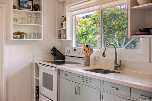 59-029 Huelo St, Haleiwa, HI 96712 - kitchen featuring open shelves, white electric stove, light countertops, and a sink