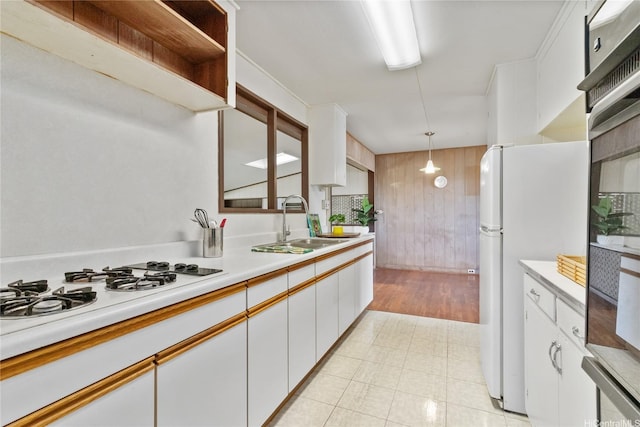 45-258 Halemuku Pl, Kaneohe, HI 96744 - kitchen with freestanding refrigerator, gas stovetop, light countertops, white cabinetry, and a sink