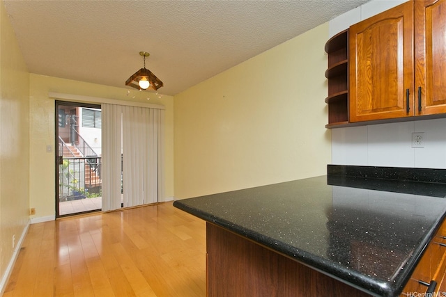 98-364 Kaonohi St Unit 11386, Aiea, HI 96701 - kitchen featuring open shelves, light wood-type flooring, brown cabinetry, baseboards, and decorative light fixtures