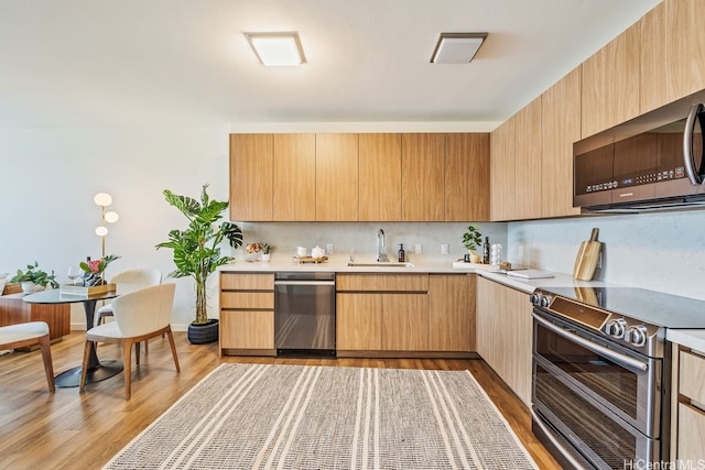1391 Kapiolani Blvd Unit 3402, Honolulu, HI 96814 - kitchen with stainless steel appliances, light countertops, a sink, and light wood-style floors