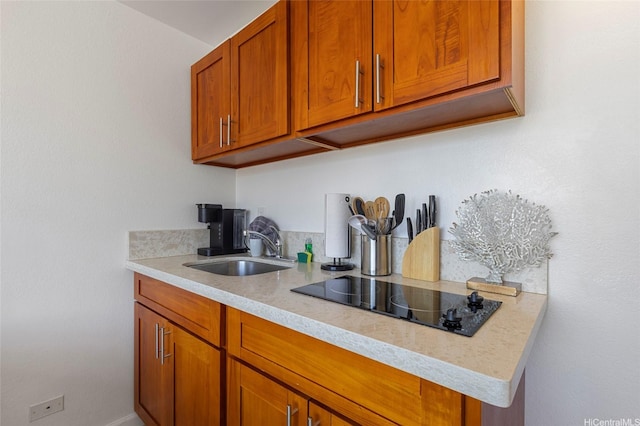 444 Niu St Unit 3508, Honolulu, HI 96815 - kitchen featuring black electric cooktop, light countertops, brown cabinets, and a sink