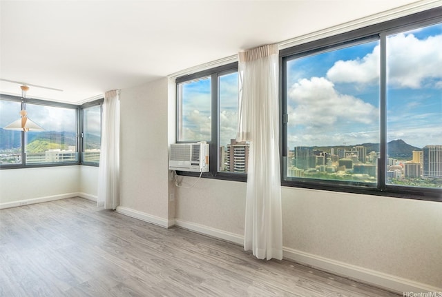 343 Hobron Ln Unit 4302, Honolulu, HI 96815 - empty room featuring baseboards, wood finished floors, and cooling unit