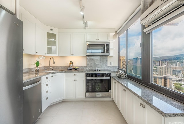 343 Hobron Ln Unit 4302, Honolulu, HI 96815 - kitchen with stainless steel appliances, a sink, glass insert cabinets, white cabinetry, and light stone countertops