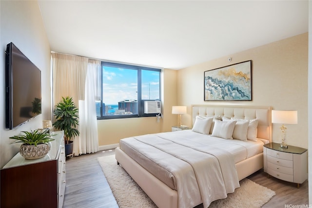 343 Hobron Ln Unit 4302, Honolulu, HI 96815 - bedroom with light wood-type flooring and baseboards