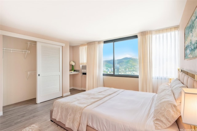 343 Hobron Ln Unit 4302, Honolulu, HI 96815 - bedroom with a closet, wood finished floors, and baseboards