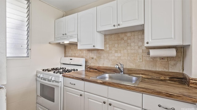 949 Ala Nanala St Unit 1201, Honolulu, HI 96818 - kitchen featuring white range with gas stovetop, a sink, under cabinet range hood, and white cabinets