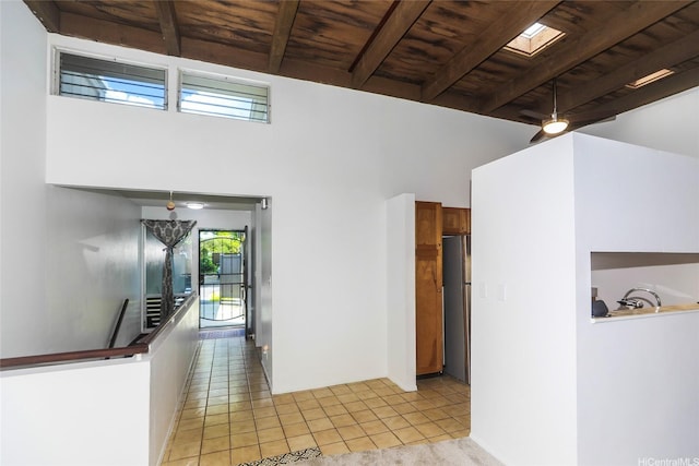 47-718 Hui Kelu St Unit 1504, Kaneohe, HI 96744 - hall with wooden ceiling with exposed beams, an upstairs landing, light tile patterned floors, and a towering ceiling