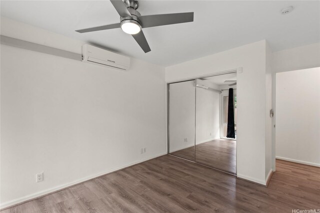 47-730 Hui Kelu St Unit 4404, Kaneohe, HI 96744 - unfurnished bedroom featuring a wall mounted AC, wood finished floors, baseboards, a closet, and a ceiling fan
