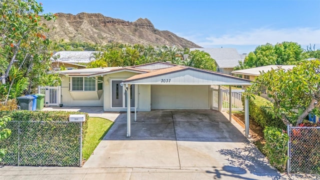 3037 Hinano St, Honolulu, HI 96815 - ranch-style home with concrete driveway, a carport, and a mountain view