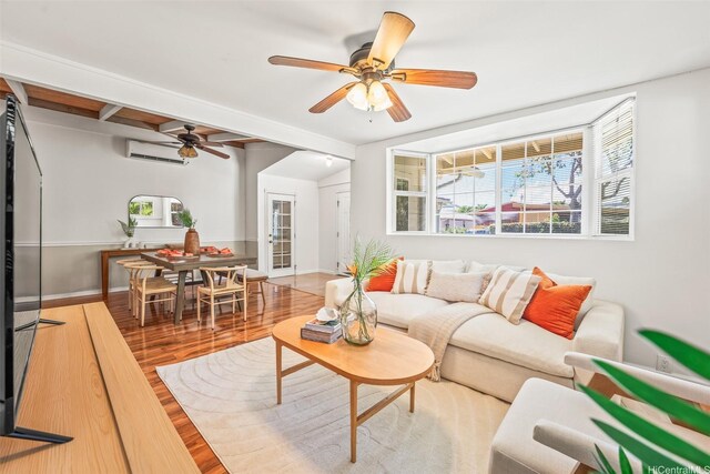 3037 Hinano St, Honolulu, HI 96815 - living room with a wall mounted air conditioner, ceiling fan, wood finished floors, and baseboards