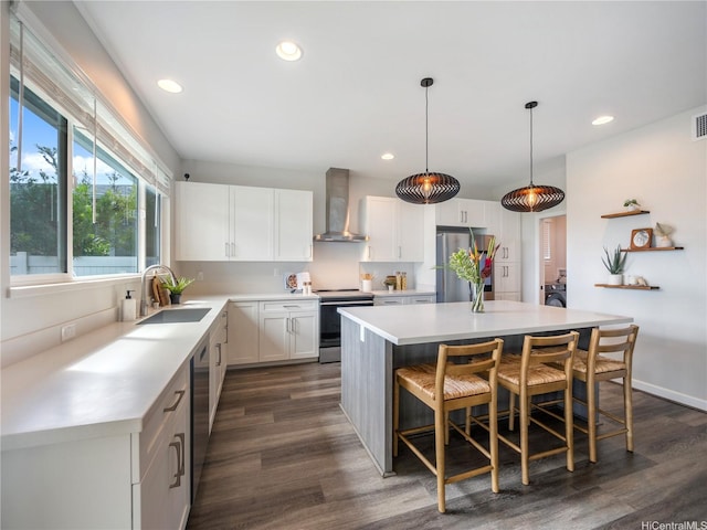 91-5408 Kapolei Pkwy Unit 37, Kapolei, HI 96707 - kitchen featuring wall chimney exhaust hood, stainless steel appliances, light countertops, white cabinets, and a breakfast bar area