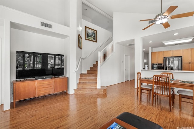 91-818 Lualai St Unit 69, Ewa Beach, HI 96706 - living room featuring a towering ceiling, wood finished floors, stairway, a ceiling fan, and recessed lighting