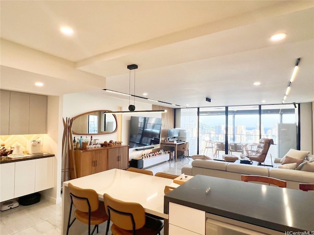 581 Kamoku St Unit 3906, Honolulu, HI 96826 - kitchen featuring white cabinets, modern cabinets, dark countertops, open floor plan, and decorative light fixtures