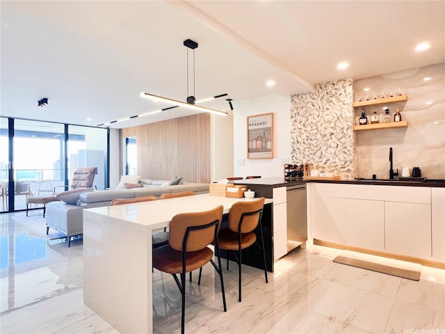 581 Kamoku St Unit 3906, Honolulu, HI 96826 - kitchen featuring a sink, stainless steel dishwasher, modern cabinets, light marble finish floors, and open floor plan