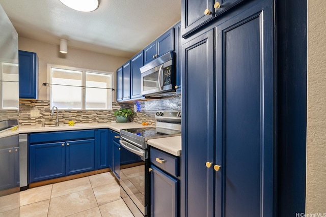 98-1369 Koaheahe Pl Unit 989, Pearl City, HI 96782 - kitchen with appliances with stainless steel finishes, a sink, blue cabinetry, and tasteful backsplash