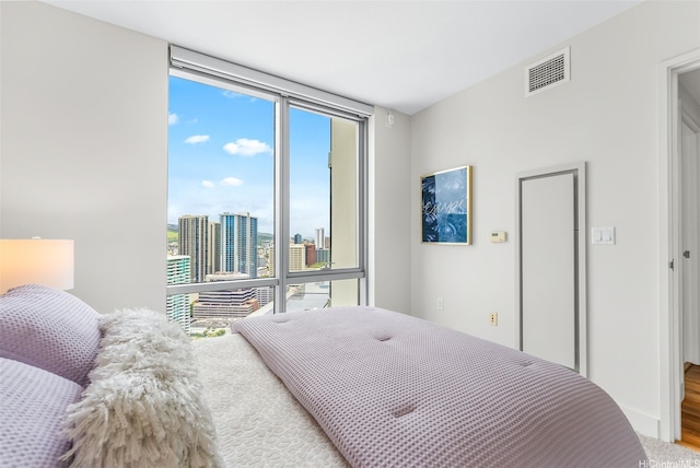1189 Waimanu St Unit 3305, Honolulu, HI 96814 - bedroom with floor to ceiling windows and wood finished floors