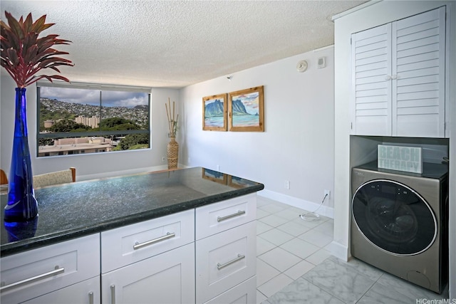 2724 Kahoaloha Ln Unit 902, Honolulu, HI 96826 - laundry room featuring washer / clothes dryer, cabinet space, a textured ceiling, and baseboards