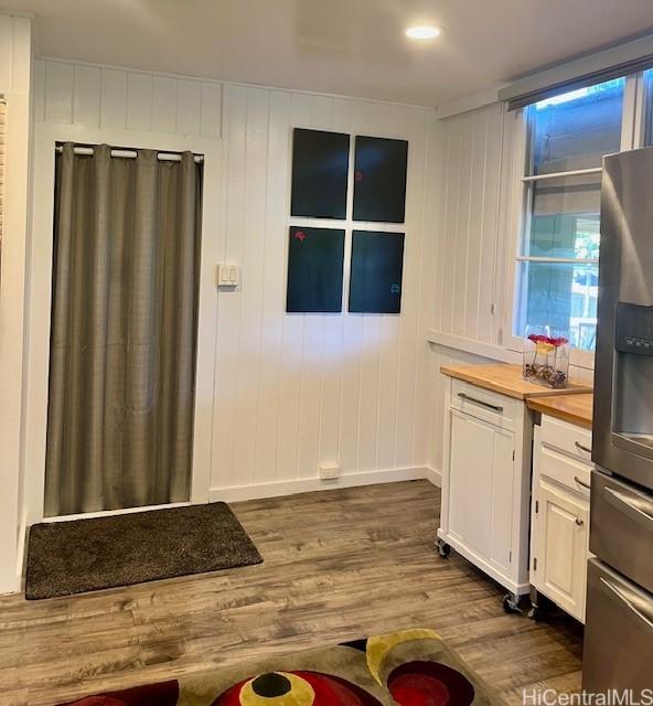 91-1708 Bond St, Ewa Beach, HI 96706 - kitchen featuring stainless steel refrigerator with ice dispenser, wood counters, dark wood-type flooring, baseboards, and white cabinetry