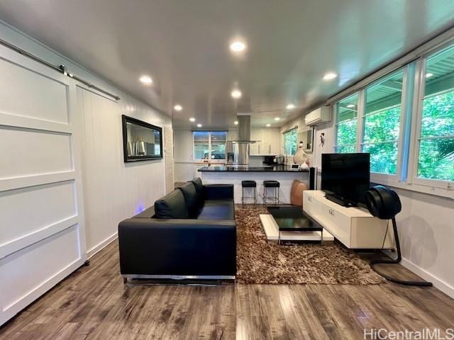91-1708 Bond St, Ewa Beach, HI 96706 - living room with an AC wall unit, wood finished floors, baseboards, and recessed lighting